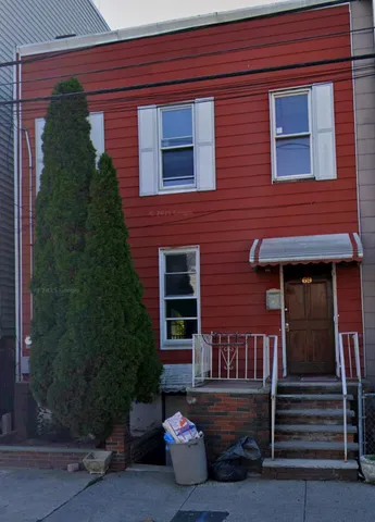 a brick building with a small yard