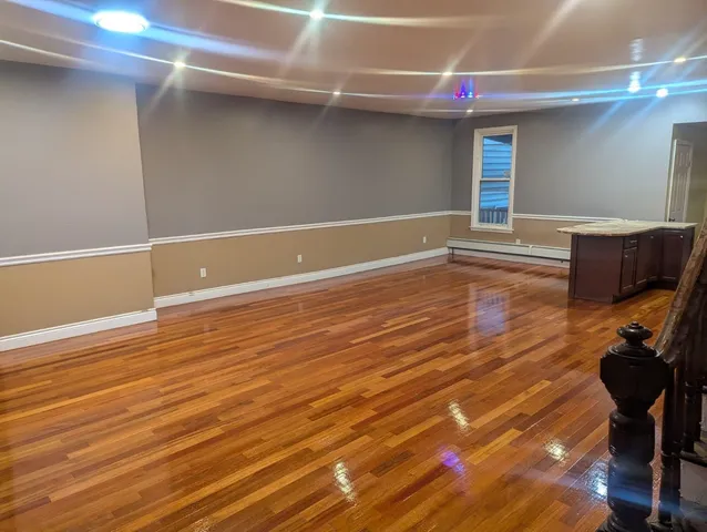a view of a room with wooden floor and chair