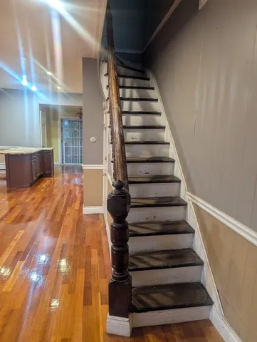 a view of entryway and hall with wooden floor