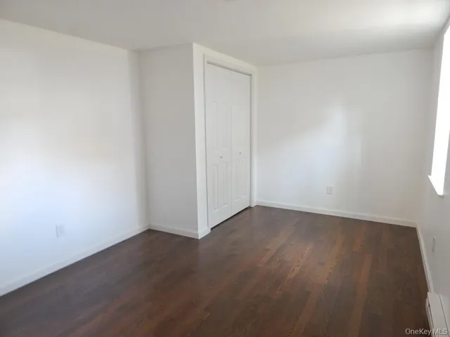 an empty room with wooden floor