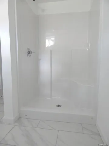 a view of a room with wooden floor and a window