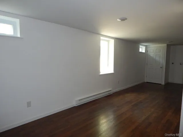 a view of a house with a small yard and wooden fence