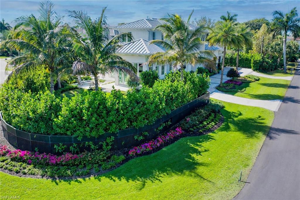 330 Broad Avenue North Naples, FL 34102 - Photo 2 of 49 With view into private backyard, fire pit outdoor living