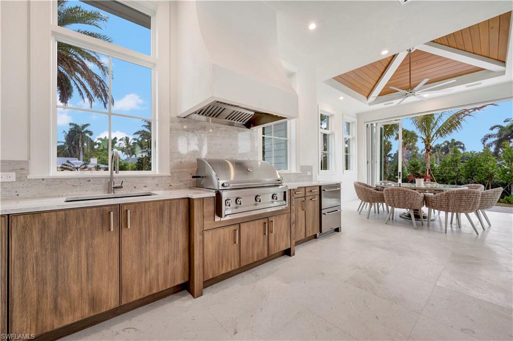 330 Broad Avenue North Naples, FL 34102 - Photo 24 of 49 Sommer kitchen with grill, refrigerator and commercial exhaust hood