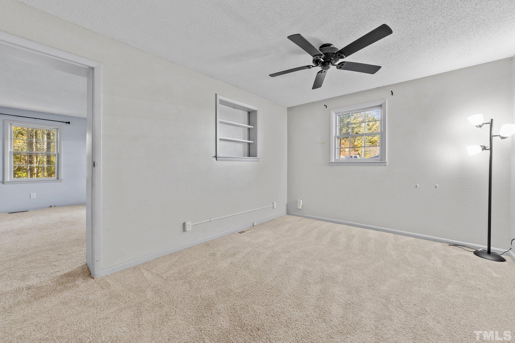8104 Falls Of Neuse Road Raleigh, NC 27615 - Photo 11 of 15 an empty room with a ceiling fan and window
