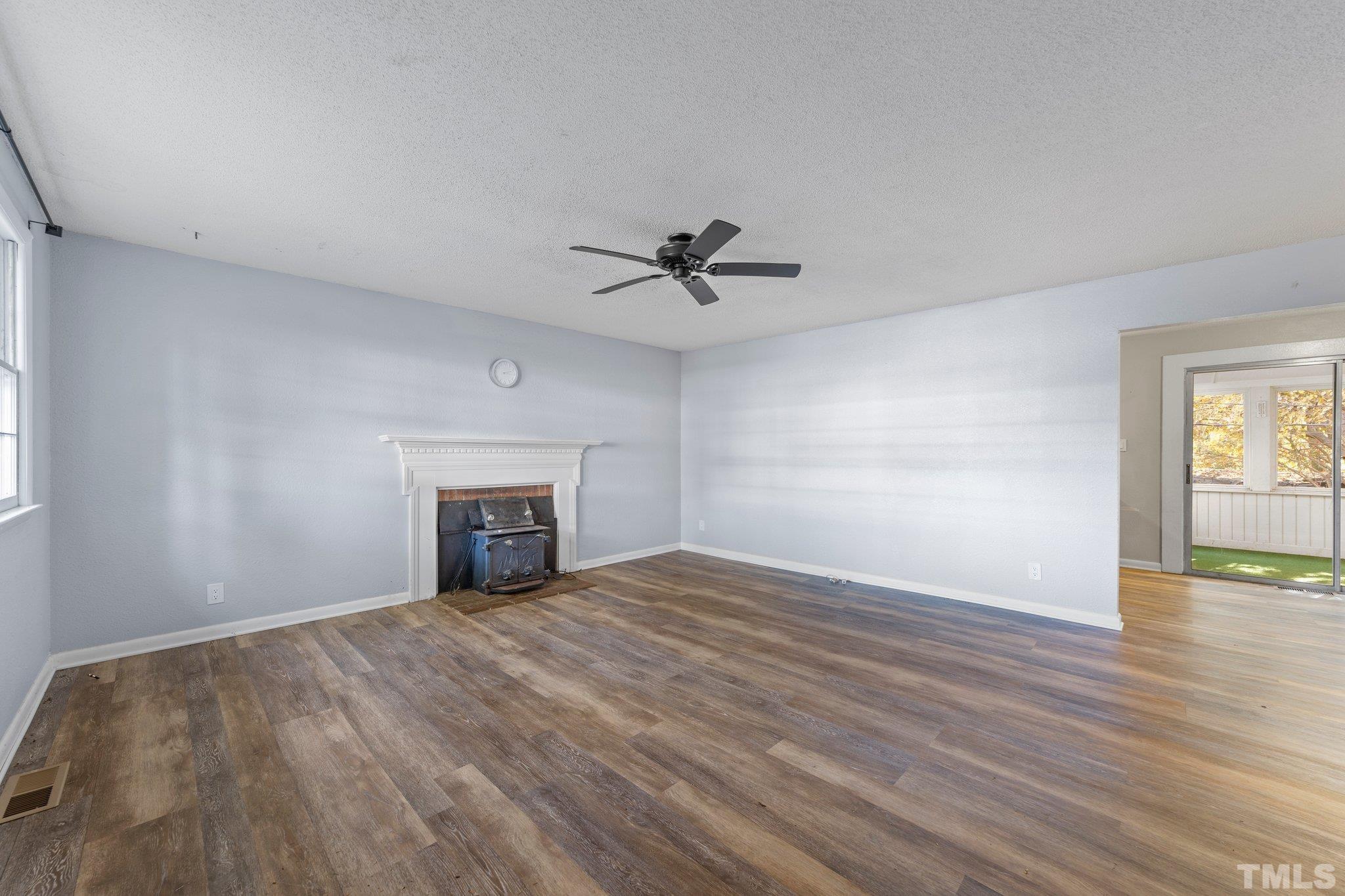 8104 Falls Of Neuse Road Raleigh, NC 27615 - Photo 8 of 15 wooden floor in an empty room with a window