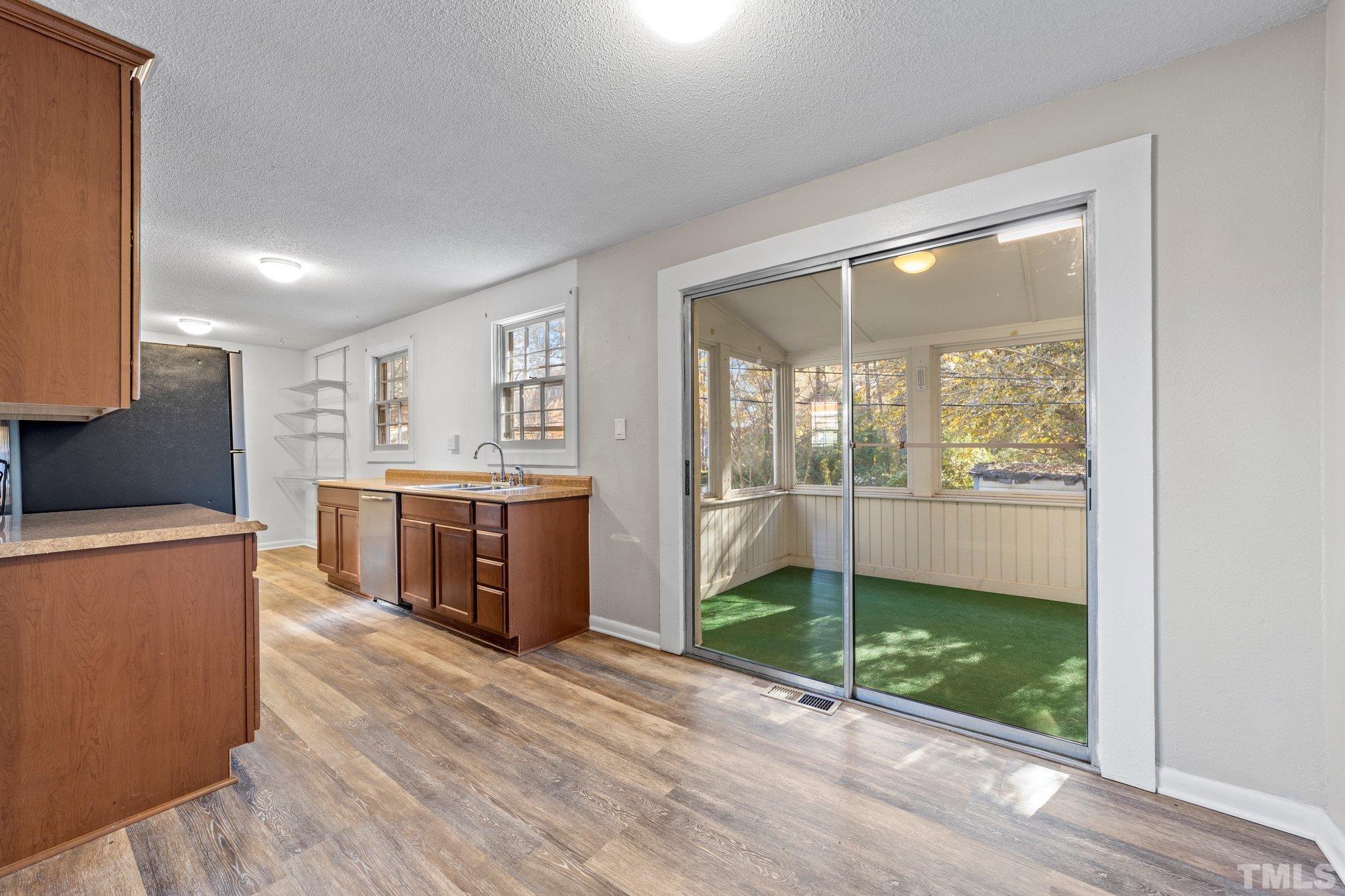 8104 Falls Of Neuse Road Raleigh, NC 27615 - Photo 10 of 15 a kitchen with stainless steel appliances wooden floor and window