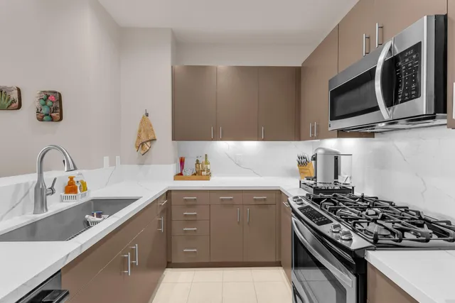 a kitchen with a sink stove and microwave