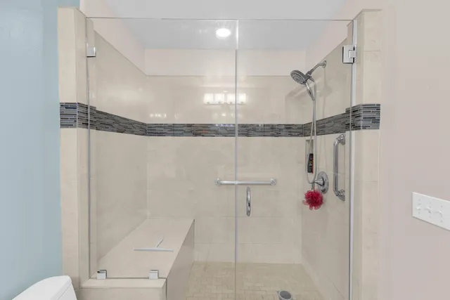 a bathroom with a shower and a shower