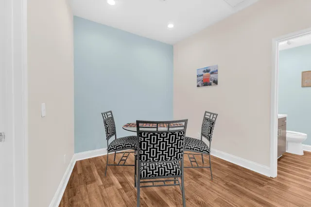 a view of a dining room with furniture and wooden floor
