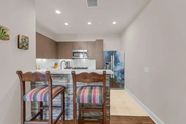 a living room with furniture and kitchen view