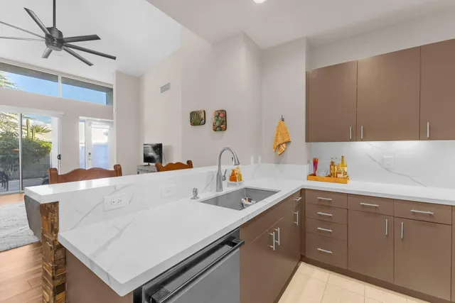 a kitchen with a sink a stove and cabinets