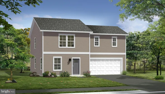 a front view of a house with a yard and trees