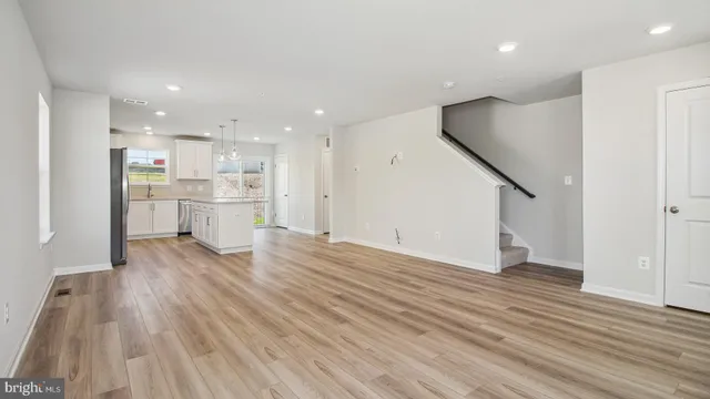 a view of kitchen with wooden floor and electronic appliances