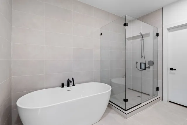 a white bath tub sitting next to a shower