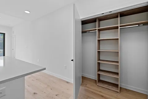 a view of walk in closet with empty racks