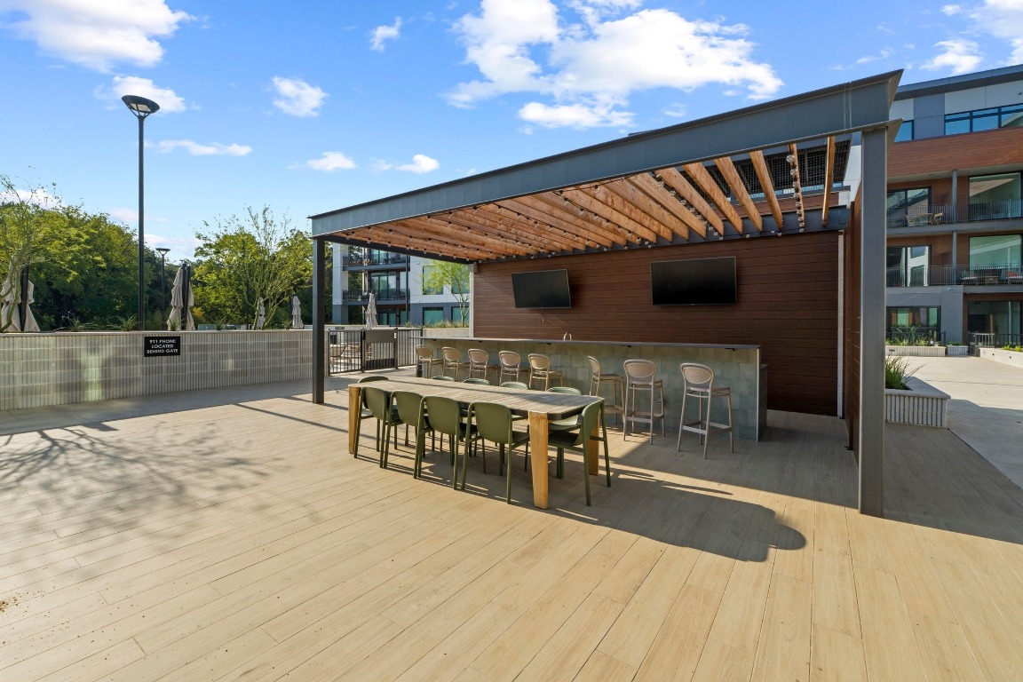 2209 South 1st Street, Unit 122 Austin, TX 78704 - Photo 30 of 40 a view of a patio with table and chairs with wooden floor