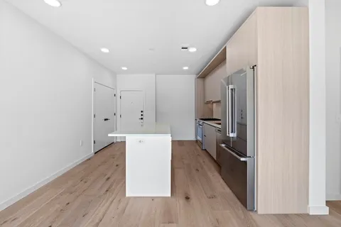 a view of a kitchen with wooden floor