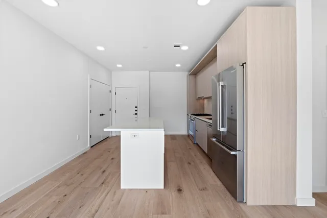 a view of a kitchen with wooden floor