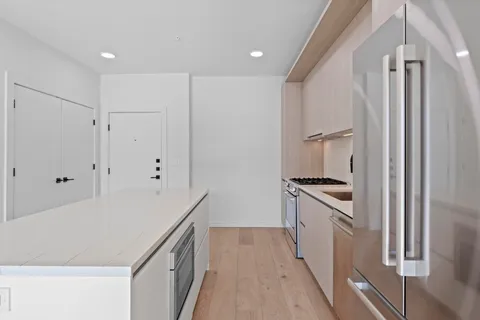 a kitchen with granite countertop a refrigerator and a stove