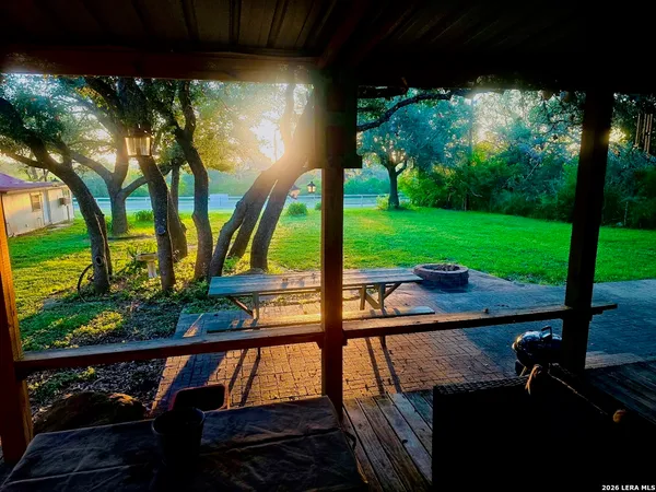 a view of a porch with furniture and garden
