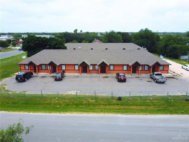 an aerial view of a house with garden space and street view