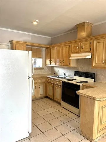 a kitchen with stainless steel appliances kitchen island granite countertop a sink a stove a microwave a counter top and cabinets