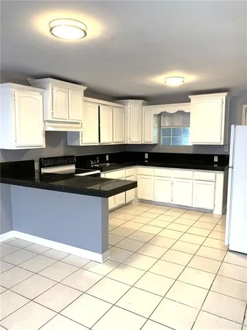 a white toilet sitting next to a bathroom sink