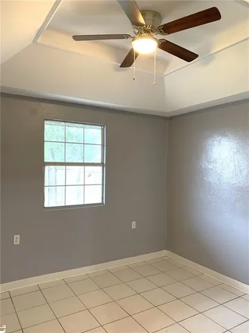 a kitchen with granite countertop white cabinets and appliances