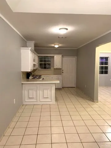 a view of kitchen with stainless steel appliances kitchen island in the center and living room