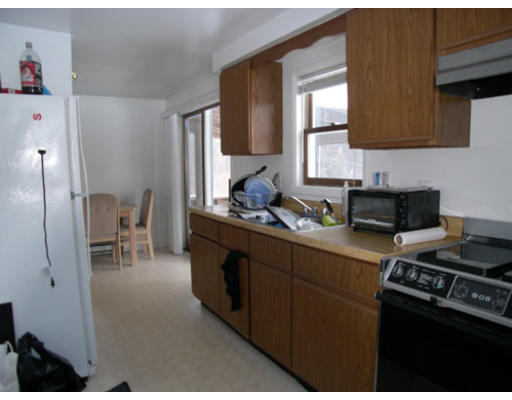 11 Clement Road Townsend, MA 01469 - Photo 3 of 8 a kitchen with stainless steel appliances granite countertop a stove a sink a refrigerator and wooden cabinets