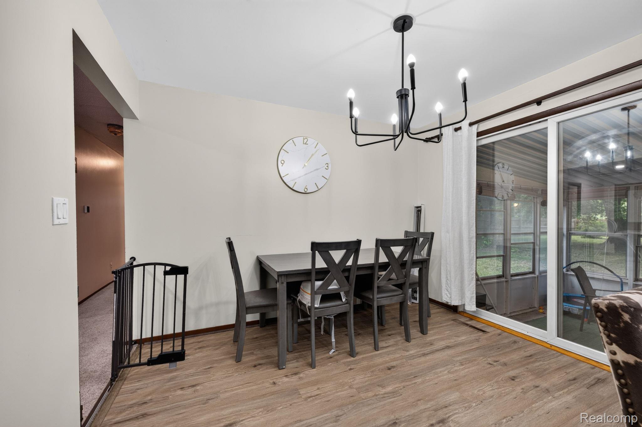 5330 Sheridan Road Saginaw, MI 48601 - Photo 15 of 50 Dining area featuring wood-finish flooring and a contemporary black chandelier