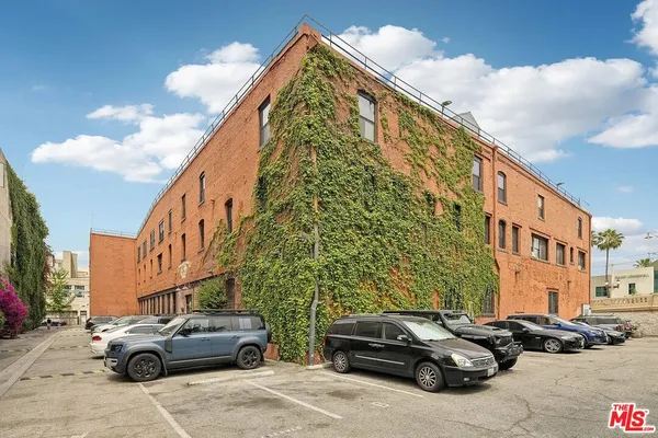 a couple of cars parked in front of a building