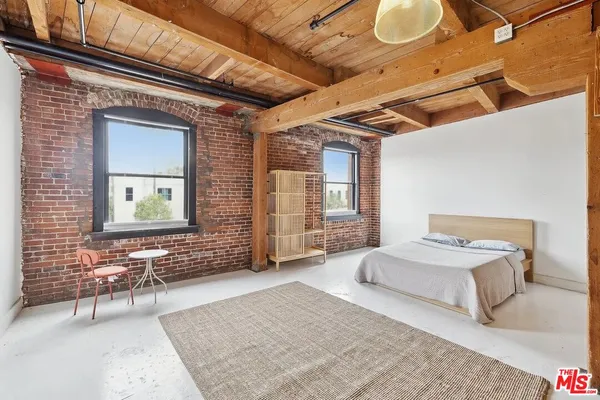 a spacious bedroom with a bed and a couch