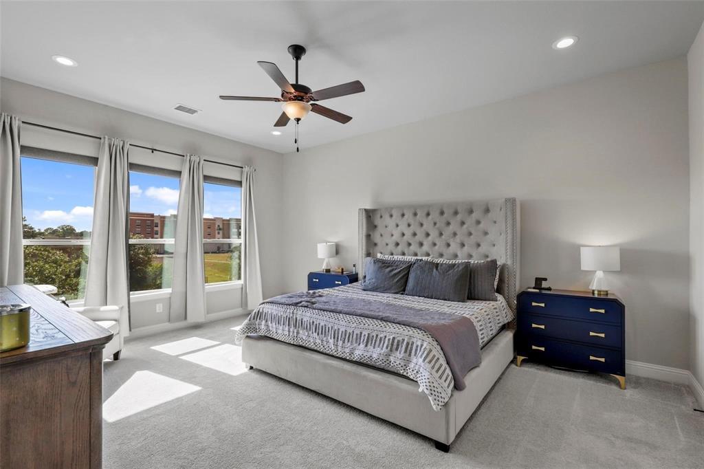 4148 Riverside Drive Flower Mound, TX 75028 - Photo 6 of 8 a bedroom with a large bed and a large window