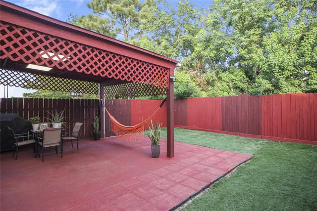 a backyard of a house with table and chairs