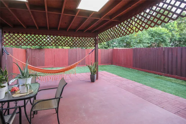 a backyard view with a seating space