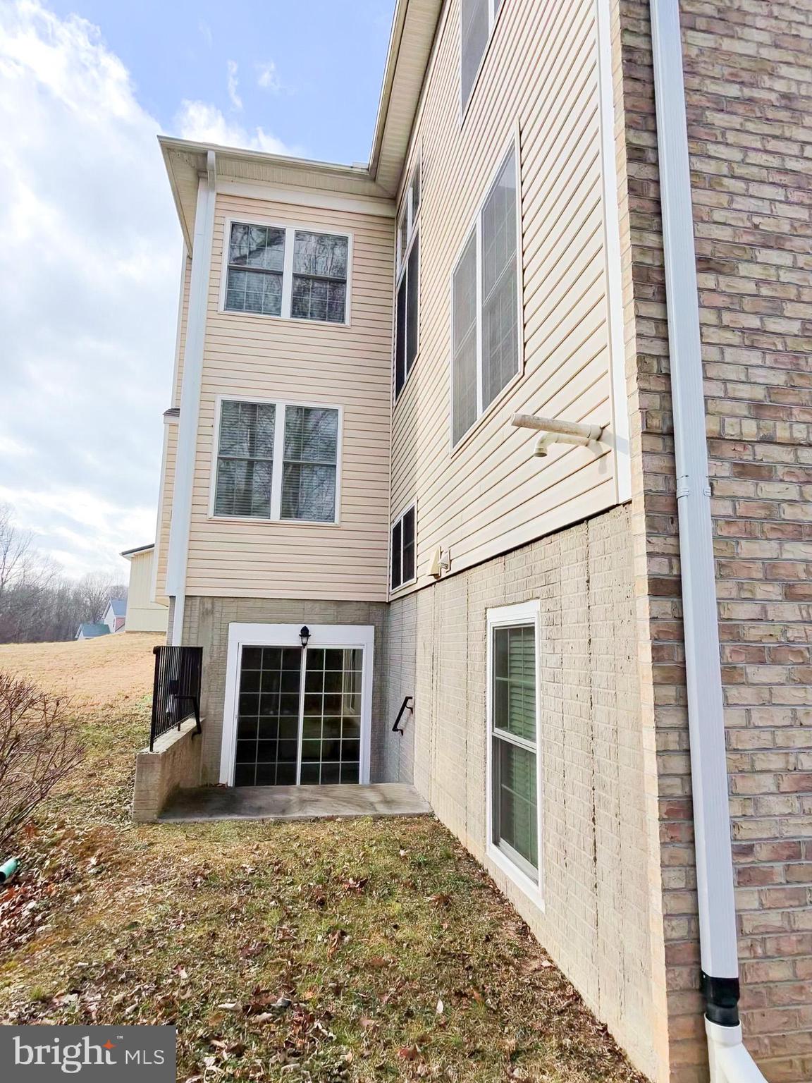 5707 Iron Stone Road Lothian, MD 20711 - Photo 4 of 90 a front view of a house with a yard
