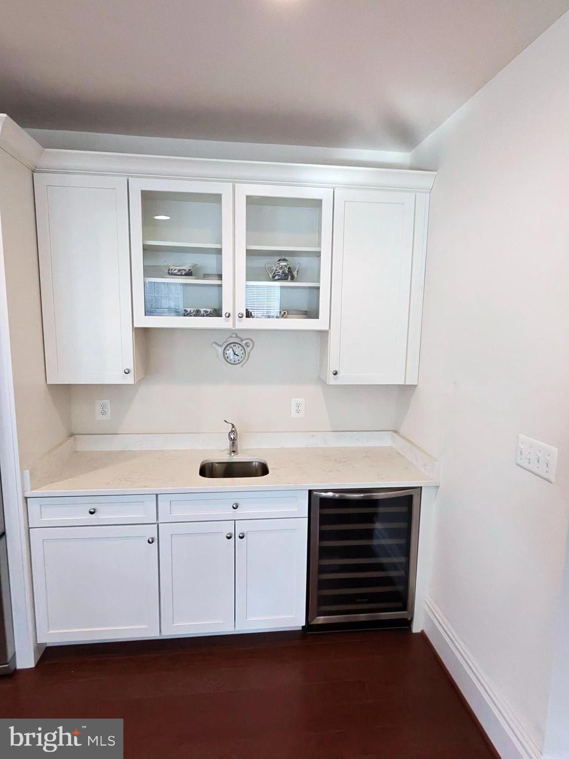 5707 Iron Stone Road Lothian, MD 20711 - Photo 5 of 90 a kitchen with stainless steel appliances a stove and white cabinets
