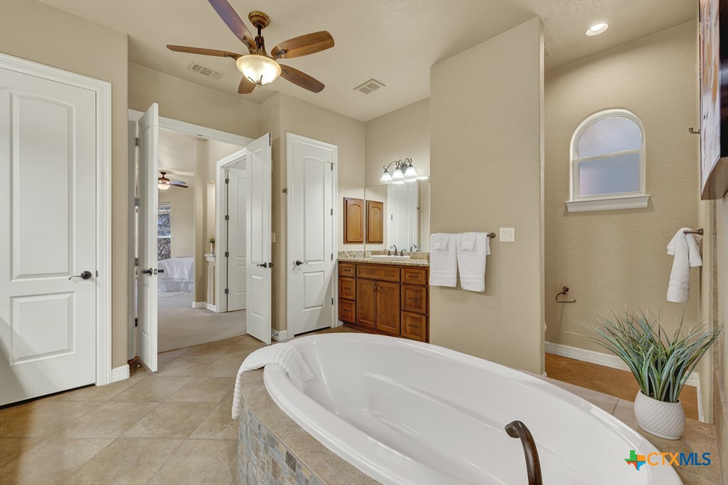 7607 Sky Loop Garden Ridge, TX 78266 - Photo 8 of 43 a spacious bathroom with a tub sink and shower