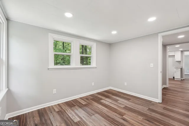 wooden floor in an empty room with a window