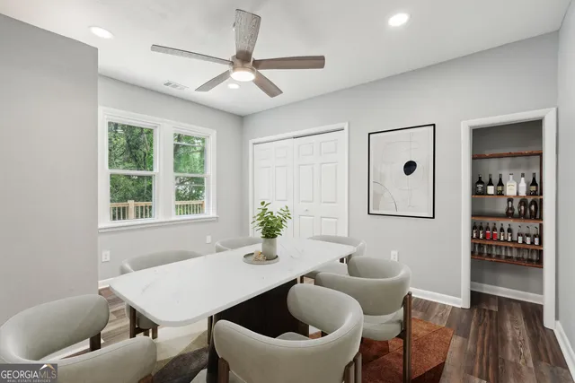 a kitchen with kitchen island wooden floors white cabinets and stainless steel appliances