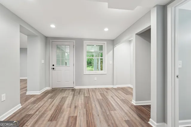 a view of a patio with couches table and chairs and wooden fence