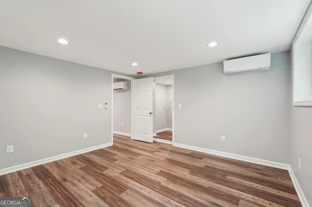 a view of a field with an ocean and trees in the background
