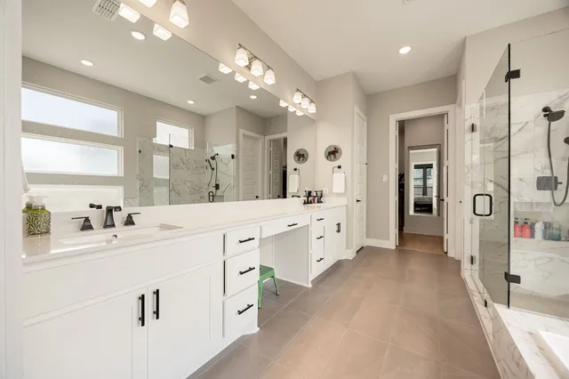 a spacious bathroom with a double vanity sink mirror and double