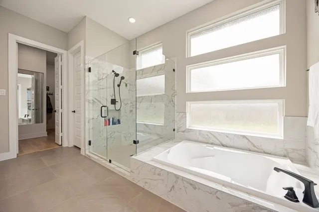 a bathroom with a bathtub and a shower