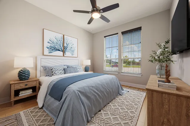 a bedroom with a large bed and a window