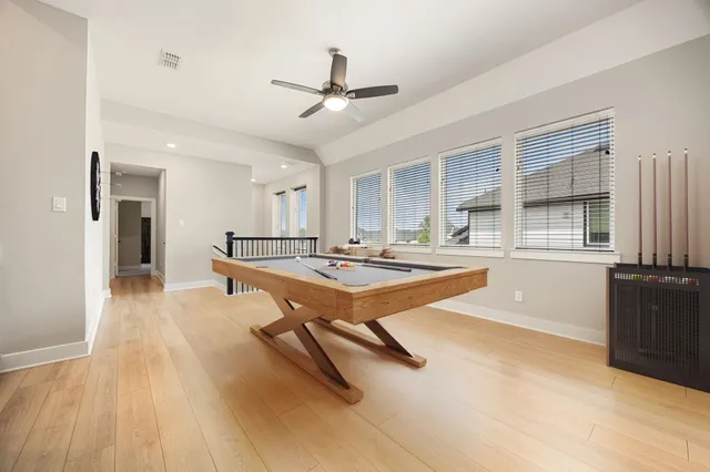 a living room with a table chairs and kitchen view