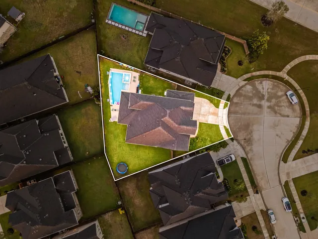 an aerial view of a house with a yard