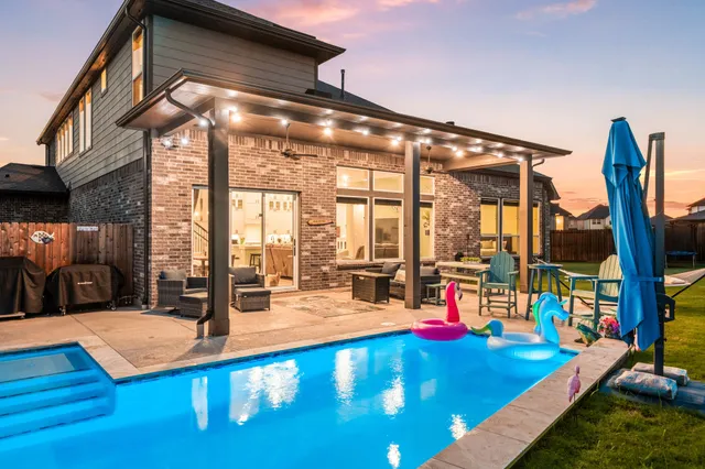 a view of a swimming pool with a patio